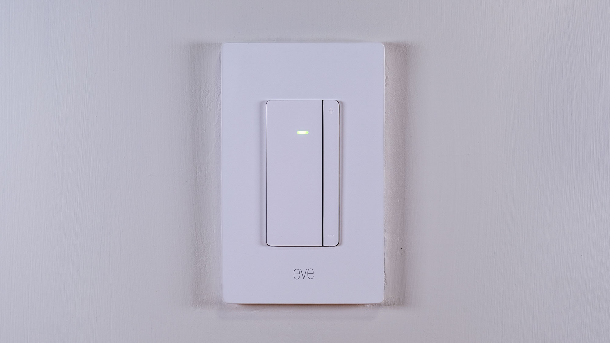 The Eve Dimmer Switch mounted on a white wall