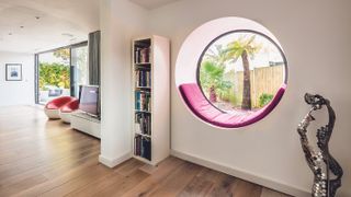 round window with pink cushion