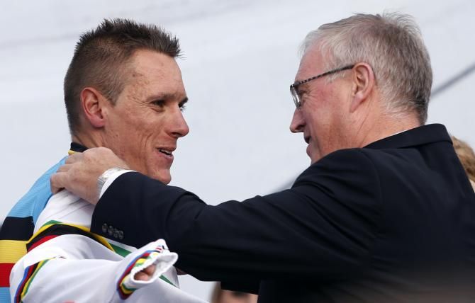 Then UCI president Pat McQuaid presents the rainbow jersey to Philippe Gilbert in 2012