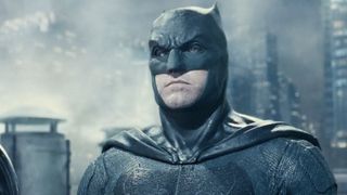 Batman (Affleck) stands on top of a Gotham skyscraper with lighting all around in Zack Snyder's Justice Leauge. 