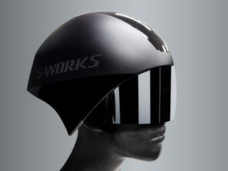Image shows a model head with a black Specialized TT5 helmet and visor