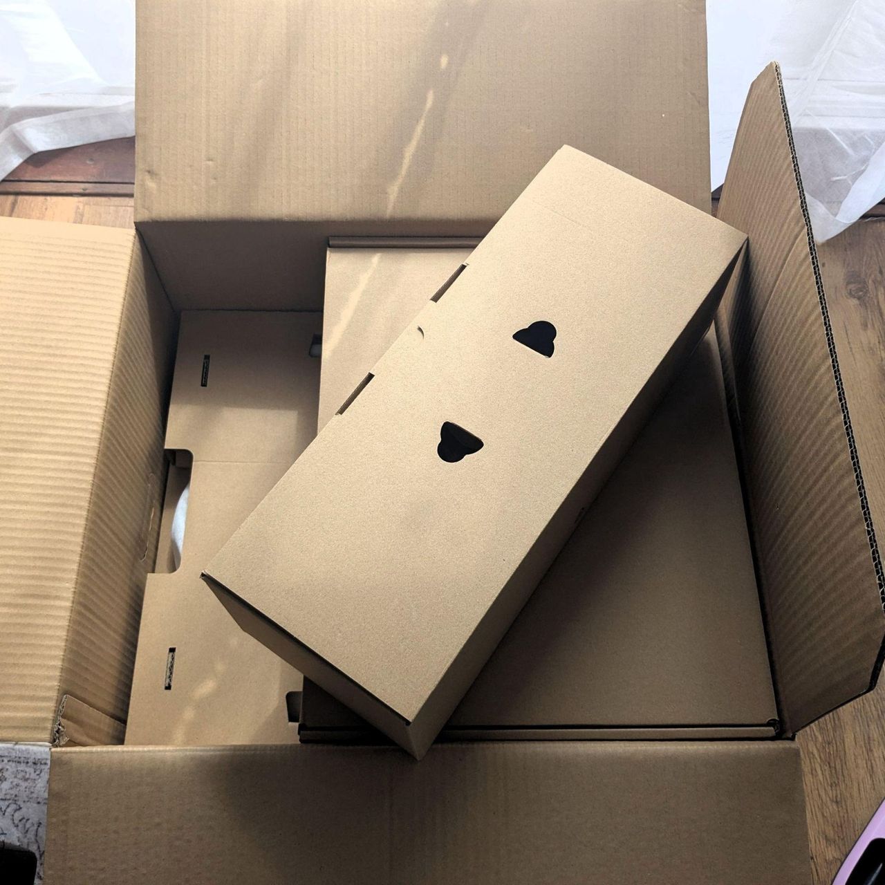 MOVA P50 Pro Ultra Robot Vacuum box, with lots of empty brown cardboard sitting on top of it, showing excessive packaging