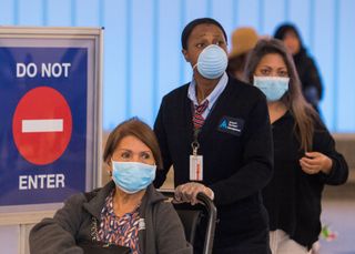passengers at LAX wear masks in the wake of the coronavirus outbreak