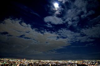 Night sky watcher Angela Saeki caught the blue moon from her balcony on the 34th floor in Osaka, Japan, August 30, 2012.