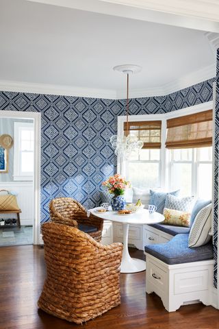 Blue wallpaper and Ralph Lauren chairs in a white setting