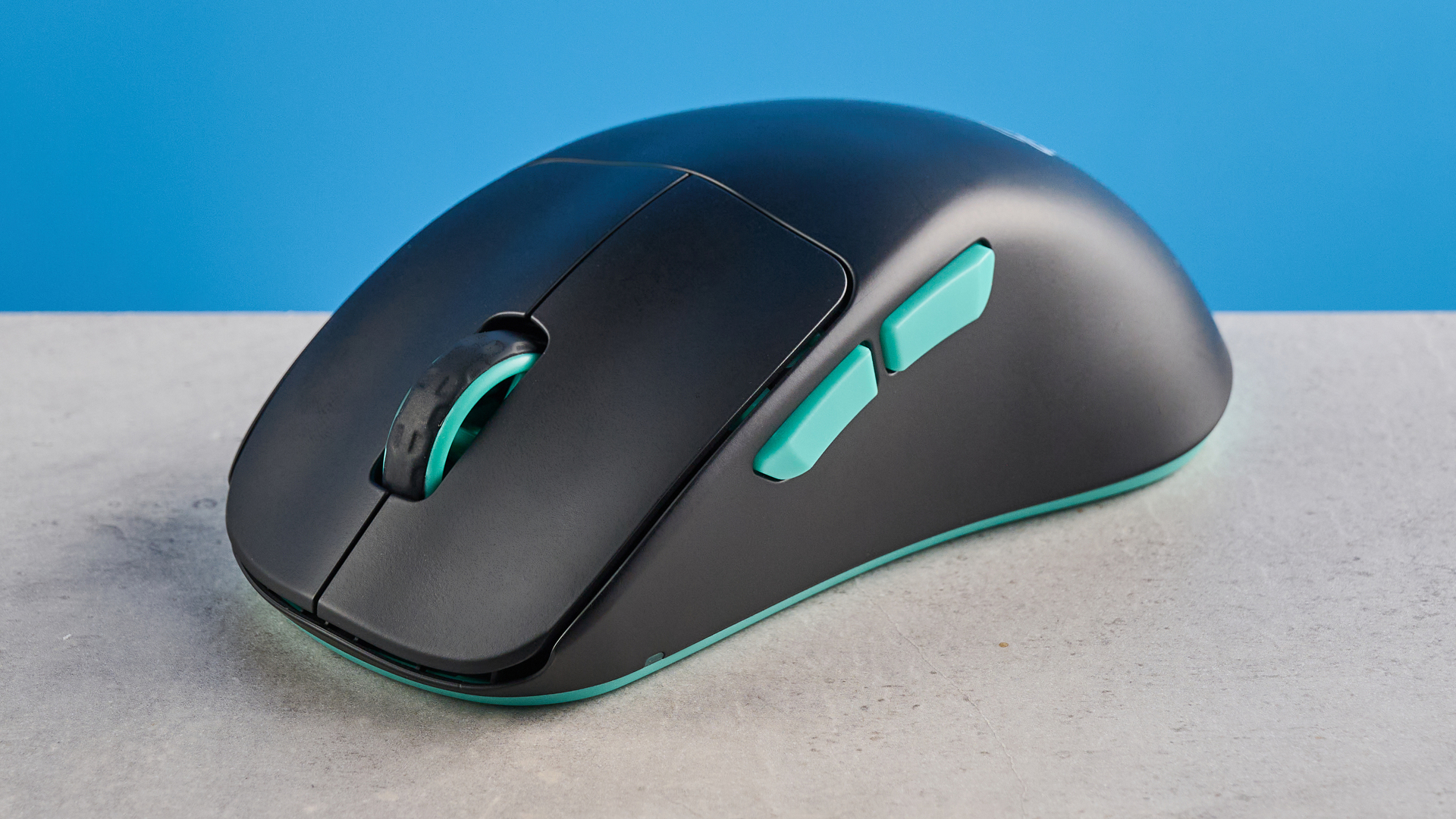 A black and teal Cherry XTRFY M64 Wireless gaming mouse