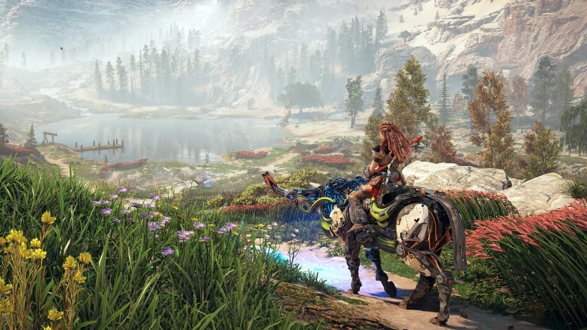 A promotional screenshot from Horizon Zero Dawn Remastered. Aloy can be seen riding a mechanical creature overlooking a lush valley.