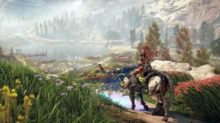 A promotional screenshot from Horizon Zero Dawn Remastered. Aloy can be seen riding a mechanical creature overlooking a lush valley.