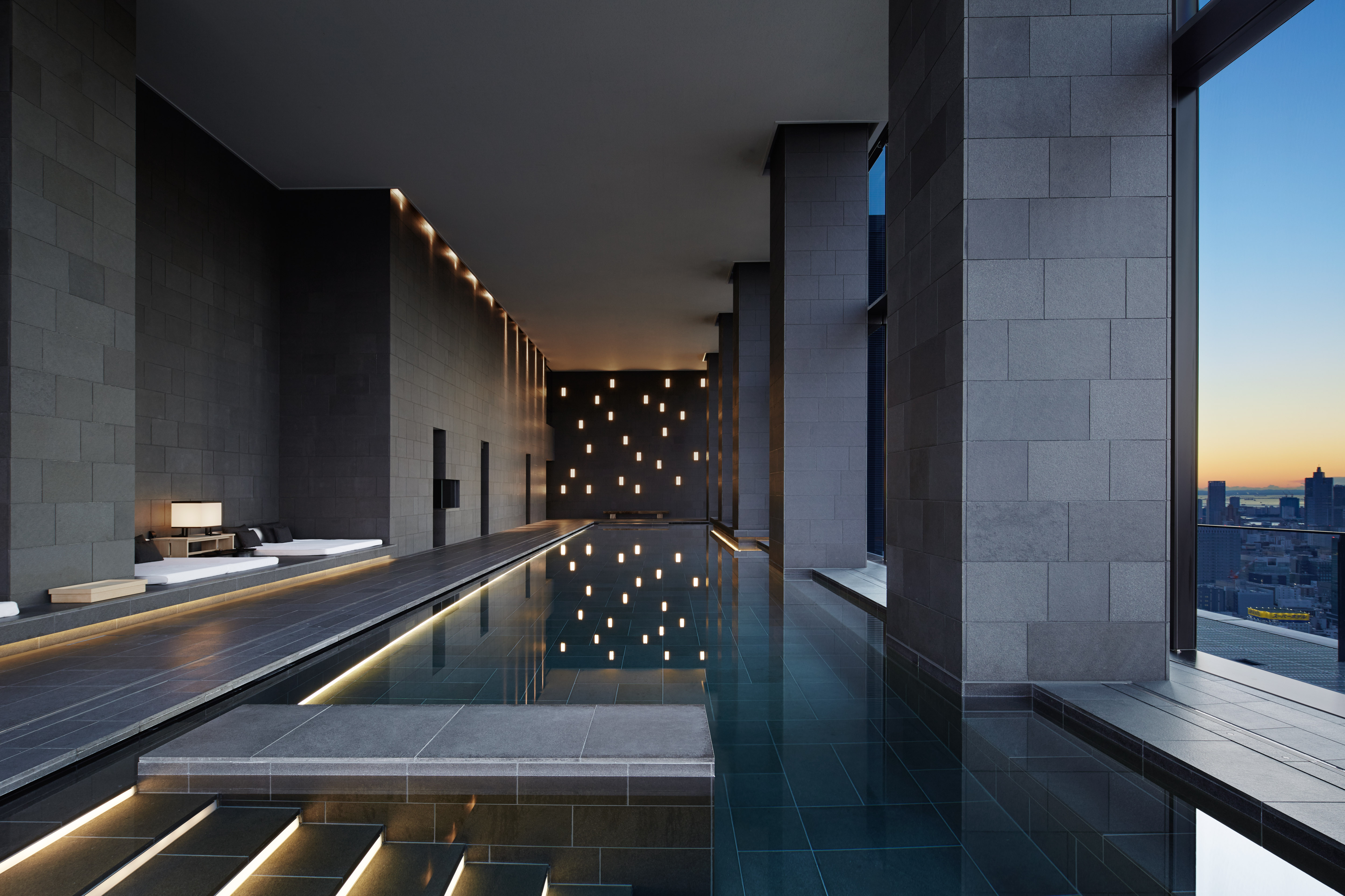 view of a serene hotel in tokyo, adorned with wooden furnishing, washi paper and natural stone touches