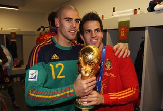 Víctor Valdés and Cesc Fàbregas celebrate with the World Cup trophy after Spain's win in South Africa in July 2010.