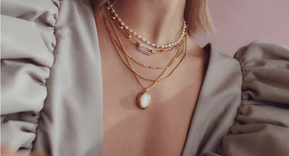 A woman wearing a selection of jewellery from Missoma Cyber Monday
