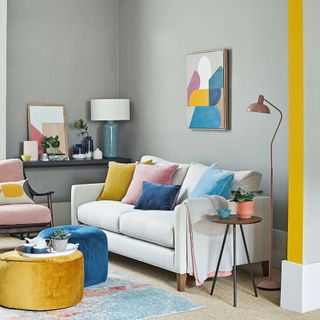 living room with white sofa and colourful cushions