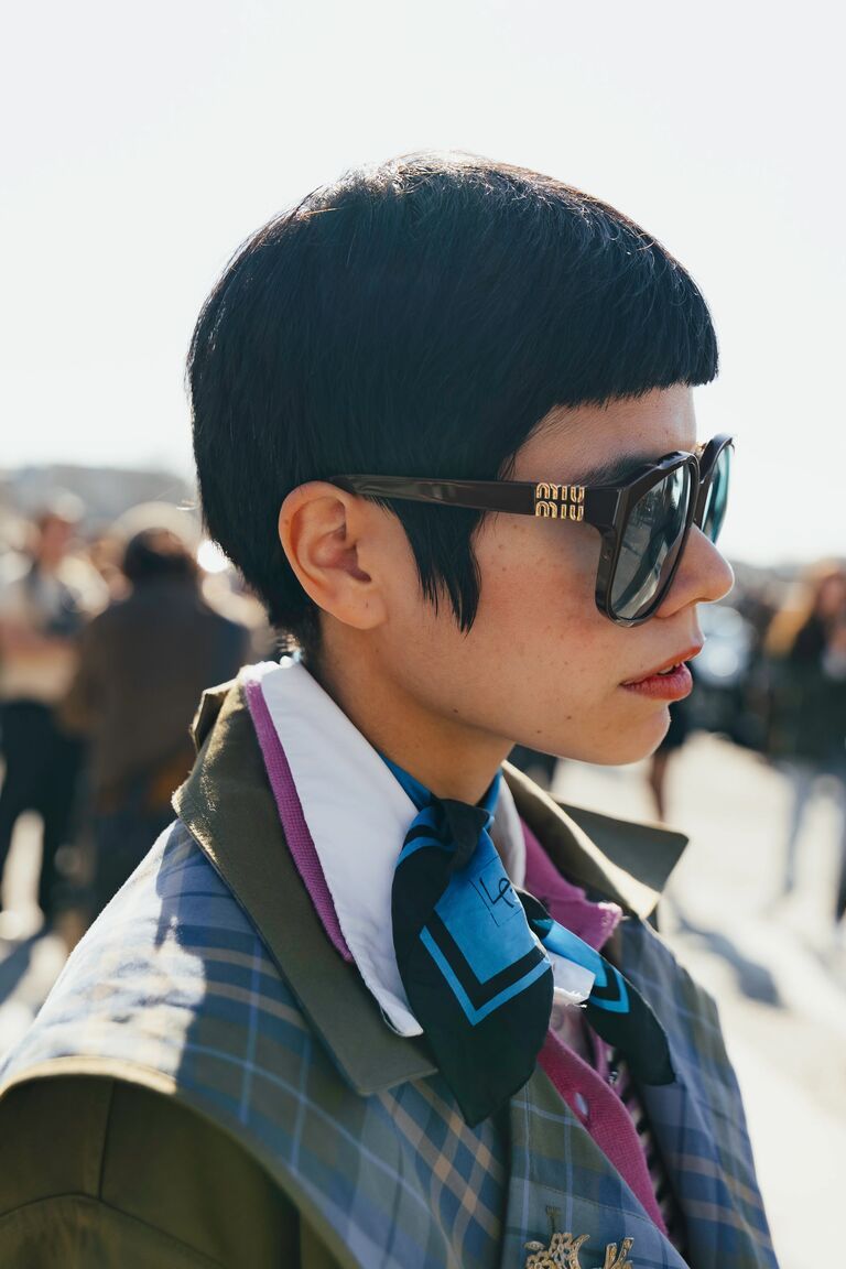 a fashion week guest wearing bug eye sunglasses
