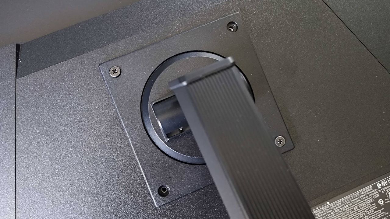 Close up of Alienware AW2726DM stand with VESA screws inserted.