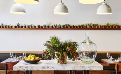 Flower vase and fruit bowl on dining table