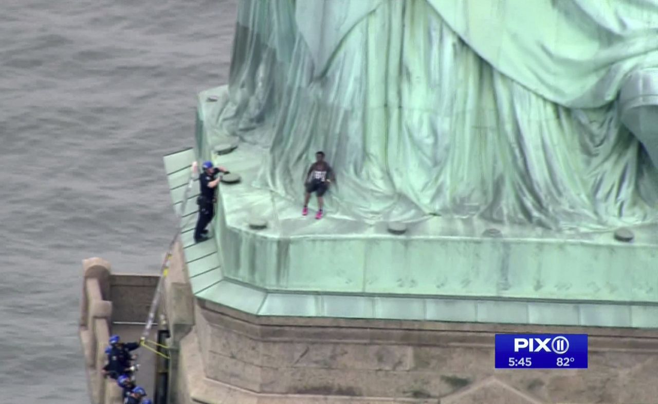 A protester at the base of the Statue of Liberty