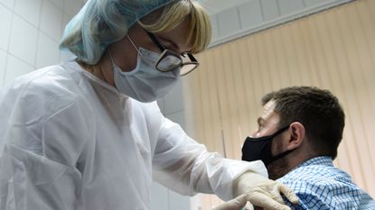 A nurse inoculates volunteer Ilya Dubrovin, 36, with Russia&amp;#039;s new coronavirus vaccine in a post-registration trials at a clinic in Moscow on September 10, 2020. 