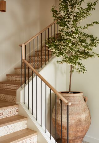staircase with tiled stairs and large planter by Lisa Staton