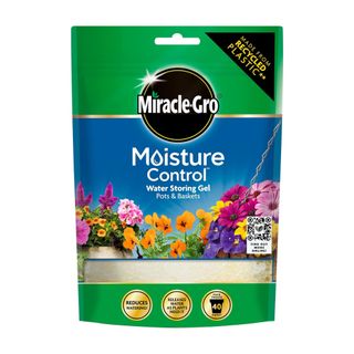 Green bag of Miracle-Gro water storing gel crystals with pictures of flowers on the front