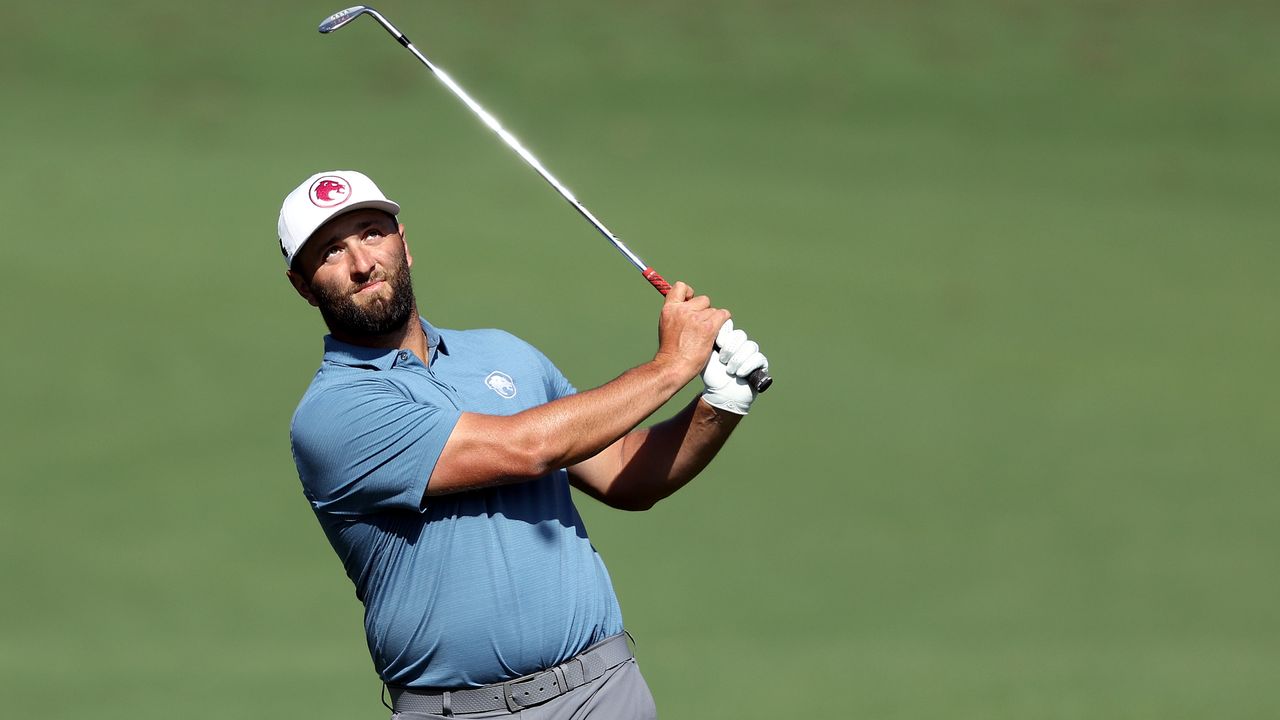 Jon Rahm hits a shot during a practice round ahead of the Masters at Augusta National