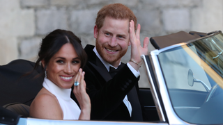 Duchess of Sussex and Prince Harry, Duke of Sussex wave as they leave Windsor Castle after their wedding to attend an evening reception at Frogmore House, hosted by the Prince of Wales on May 19, 2018 in Windsor, England