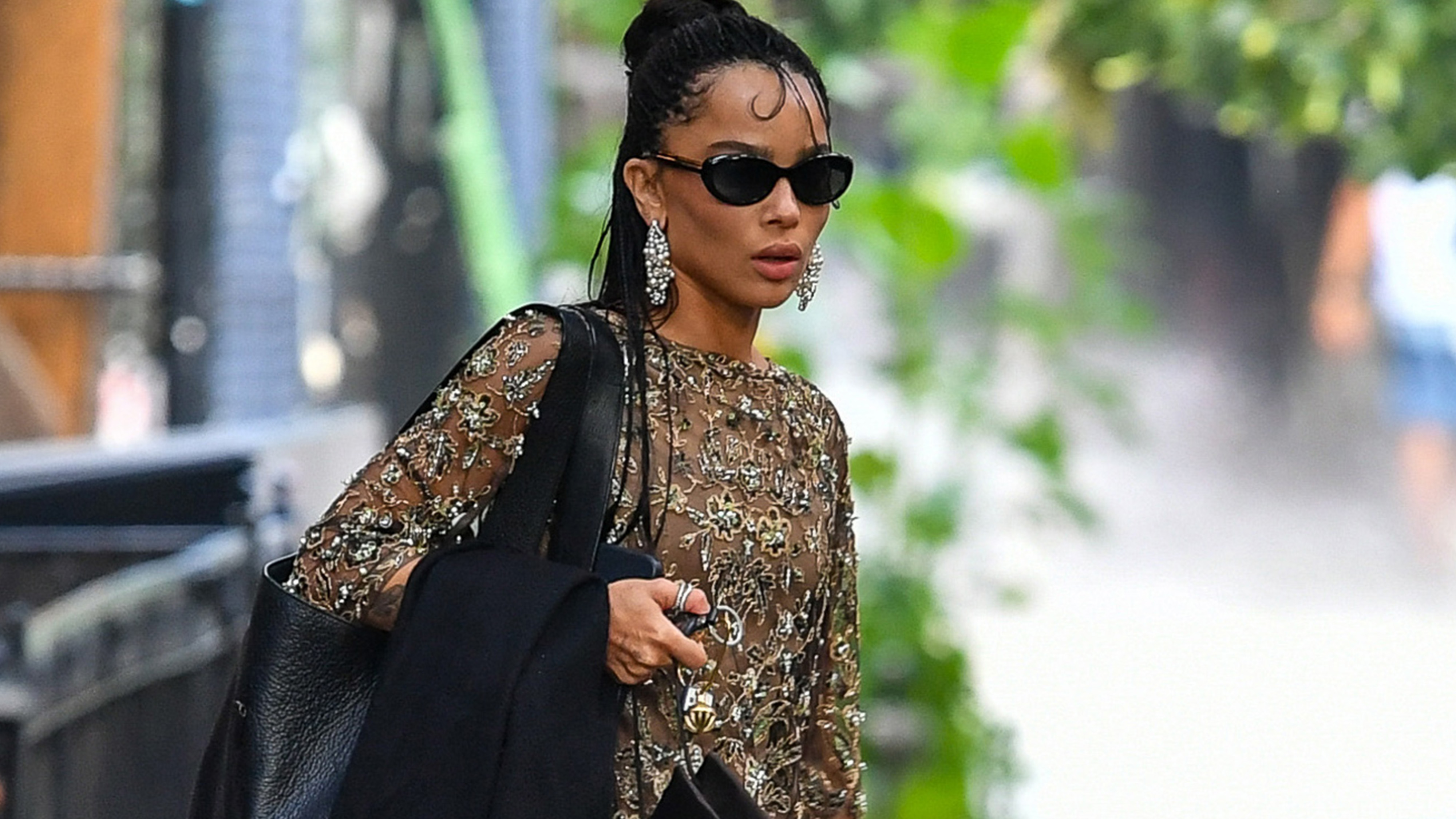 07/03/2026 EXCLUSIVE: Zoe Kravitz is spotted headed to Taylor Swift's wedding in New York City. The American actress carried a black handbag and wore a gold dress and matching heels.