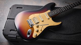 The Fender American Ultra II Stratocaster HSS lying on a black guitar carry case