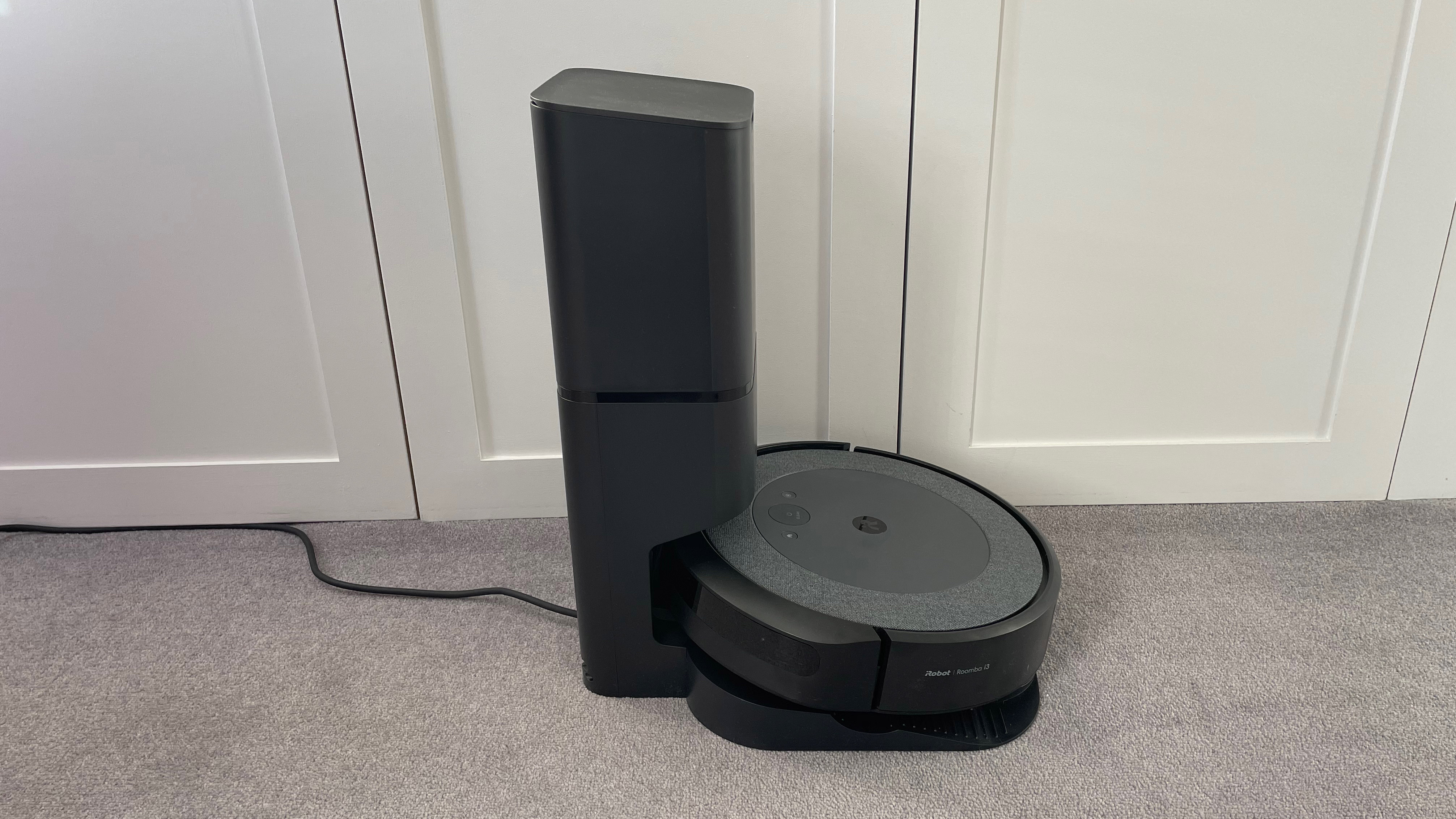 The side view of the iRobot Roomba i3 Plus on its charging base