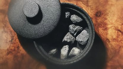 Black H&M Lava Stone Diffuser on a polished brown wood table