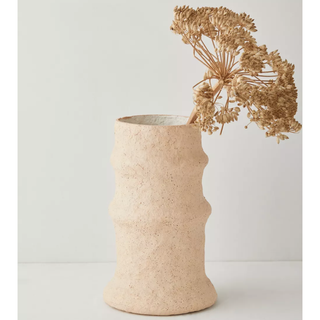 cream textured vase with dried flowers inside