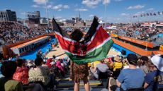 Young fan dancing with her flag in the crowd during Beach Volleyball at the Birmingham 2022 Commonwealth Games 