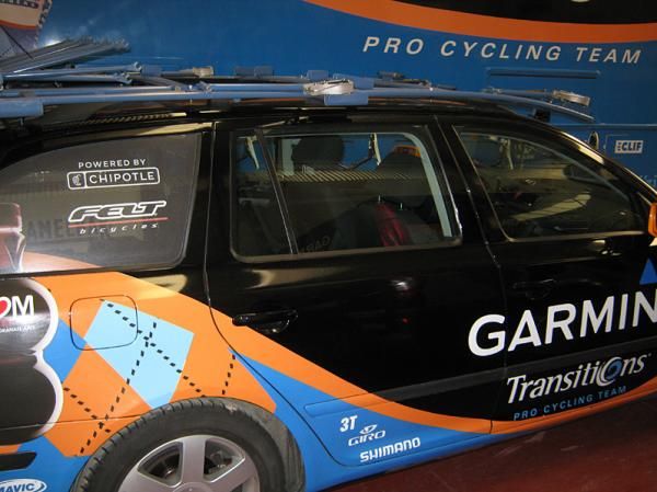 A Garmin-Transitions team car parked beside the equipment truck