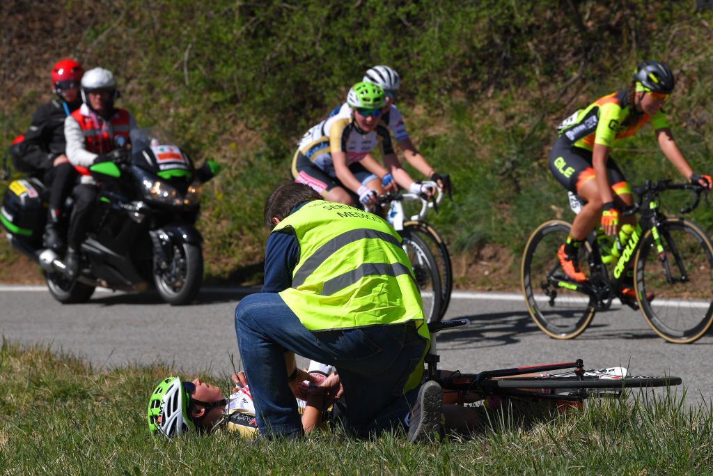 Sara Casasola lies on the side of the road after a crash