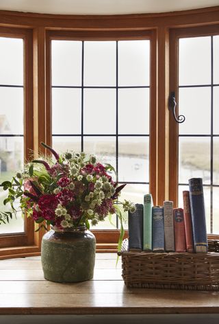 flowers and books on a window sill