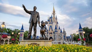 The statue outside of Cinderella's castle at Walt Disney World of Walt and Mickey Mouse.