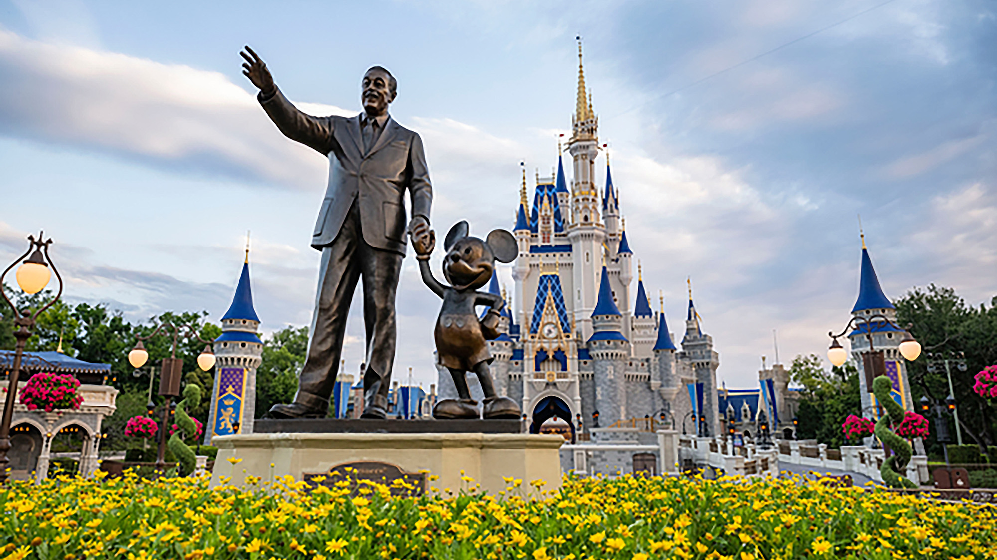 The statue outside of Cinderella's castle at Walt Disney World of Walt and Mickey Mouse.