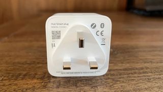 The back of the Philips Hue smart plug on a wooden countertop