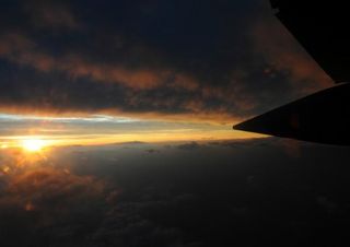 Sunrise over a hurricane. A plane makes a pass through Hurricane Bill near Canada in 2009.
