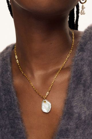 galentine's day gift ideas - woman wearing irregular pearl pendant on a gold chain