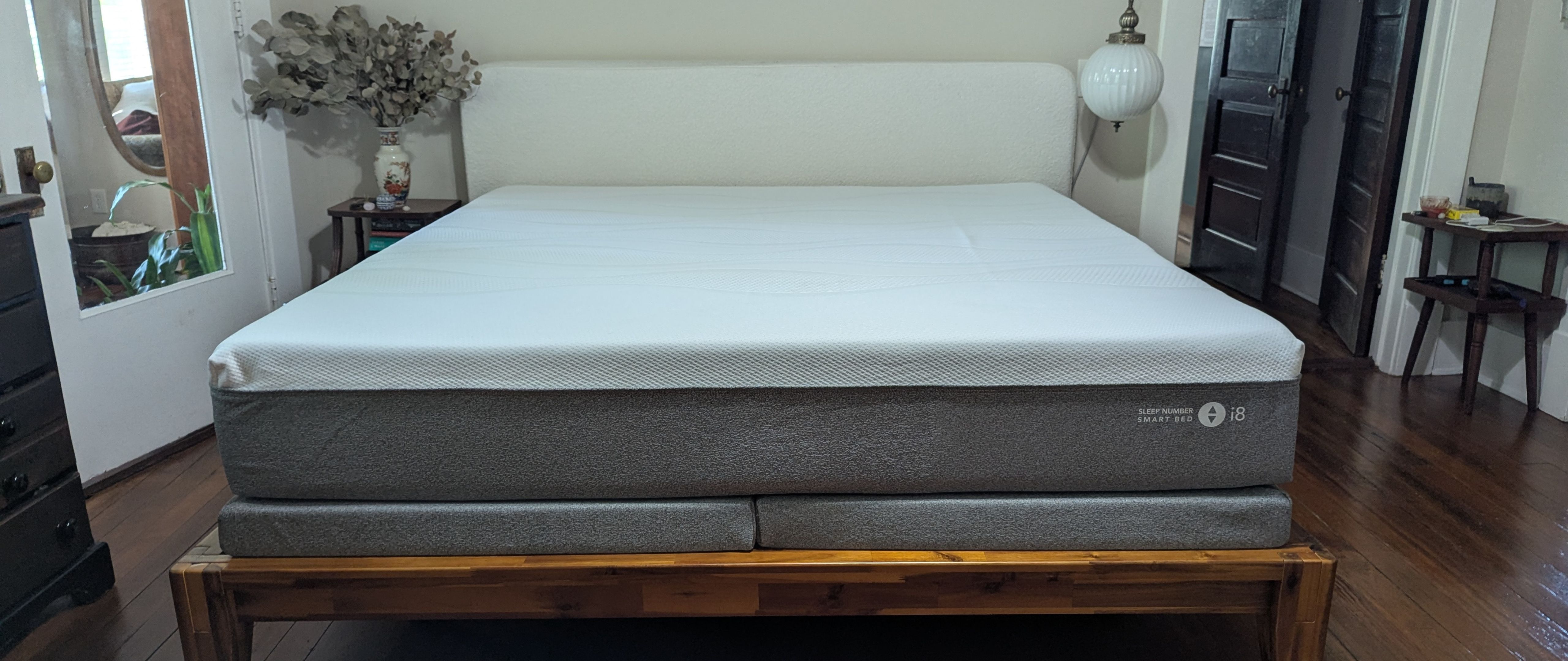 Grey and white Sleep Number i8 smart mattress on wooden bedframe 