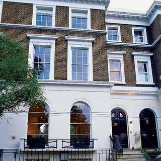 house exterior with brick wall and white window