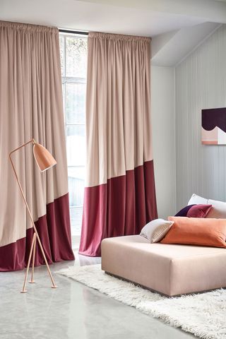 a living room with two tone curtains