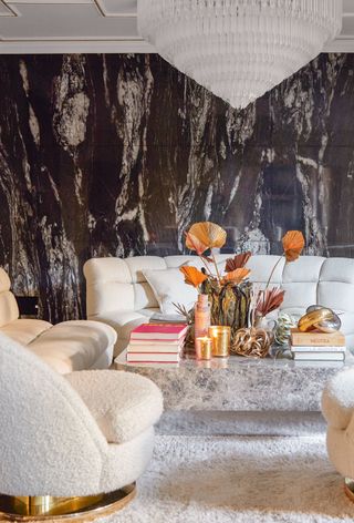 a living room with black marble wallpaper