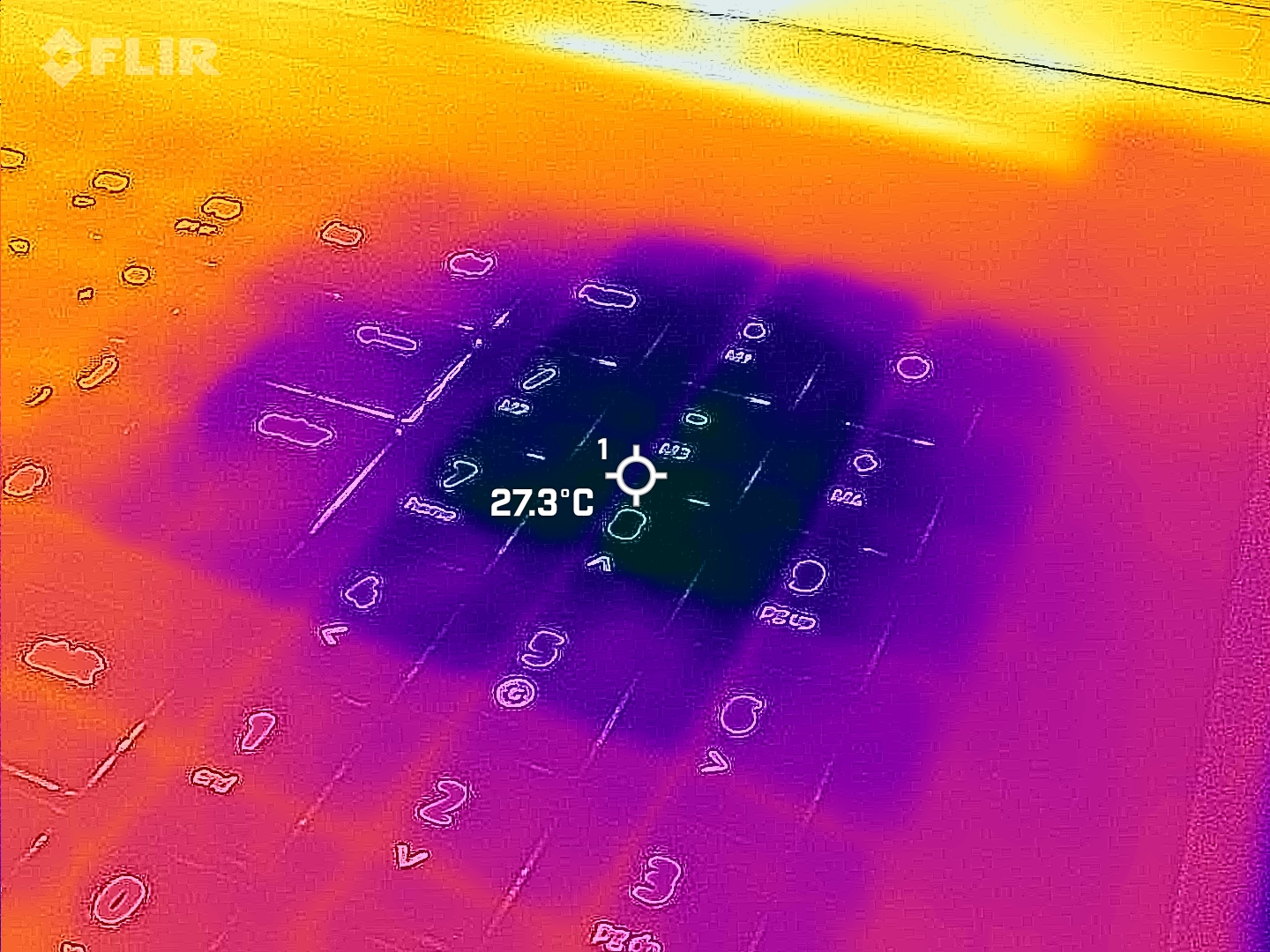 Razer Blade 18 (2025) gaming laptop viewed with a FLIR thermal camera showing hot and cool spots