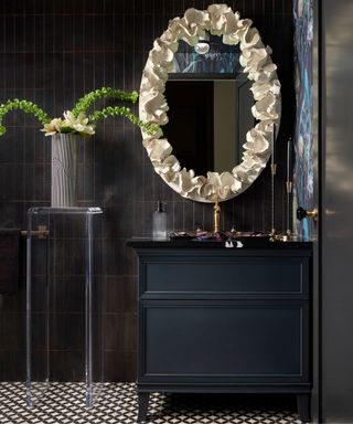 Dark bathroom with statement cream mirror