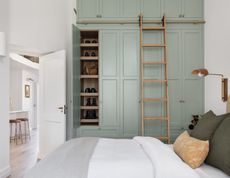 A guest bedroom with ceiling-high storage