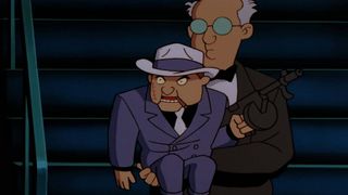 The Ventriloquist holds the dummy Scarface in Batman the Animated Series