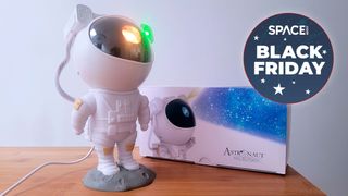 Astronaut starry sky projector on a wooden table in black friday deals