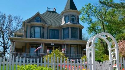 historic guesthouse with white wooden picket fence