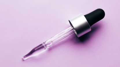 serum pipette on a purple background